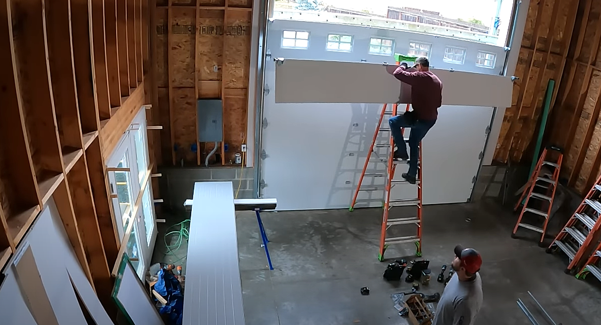 Professional technician performing a garage door section replacement at a residence in Bradenton, FL