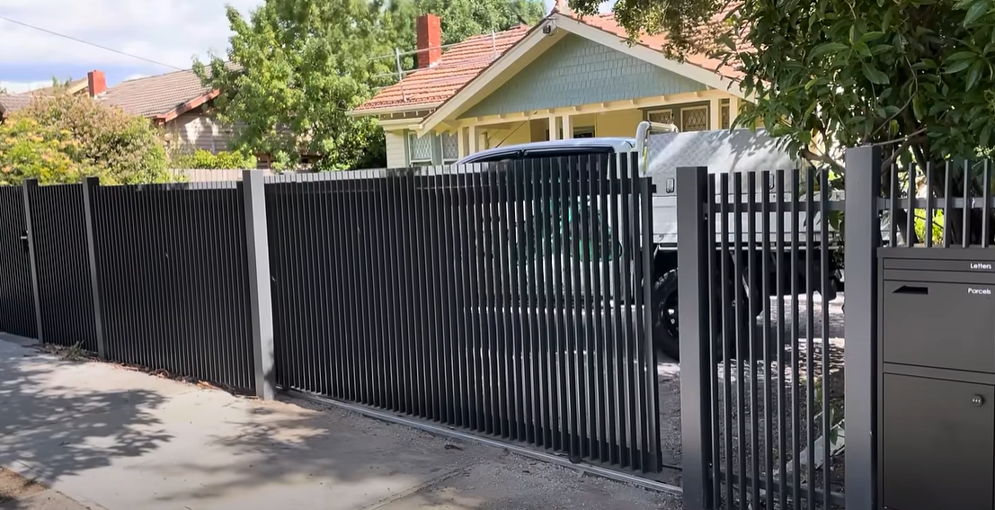 Professional technician repairing a residential gate in Bradenton, FL, specialized in residential gate repair.