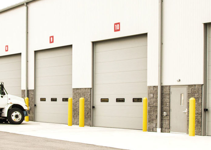 Technician performing commercial garage door repair in Bradenton, FL