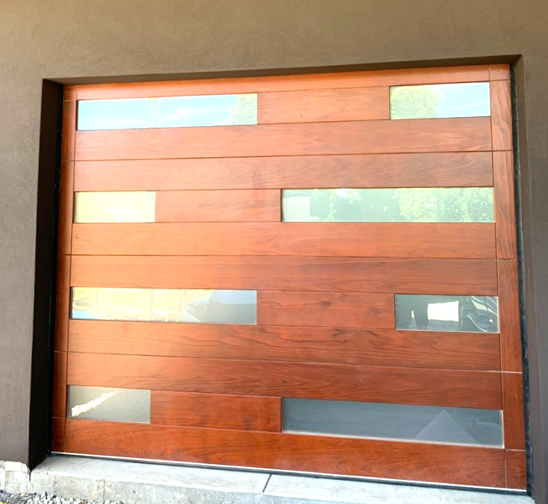 Custom garage door with intricate design and modern technology, enhancing the curb appeal of a stylish home in Bradenton, FL