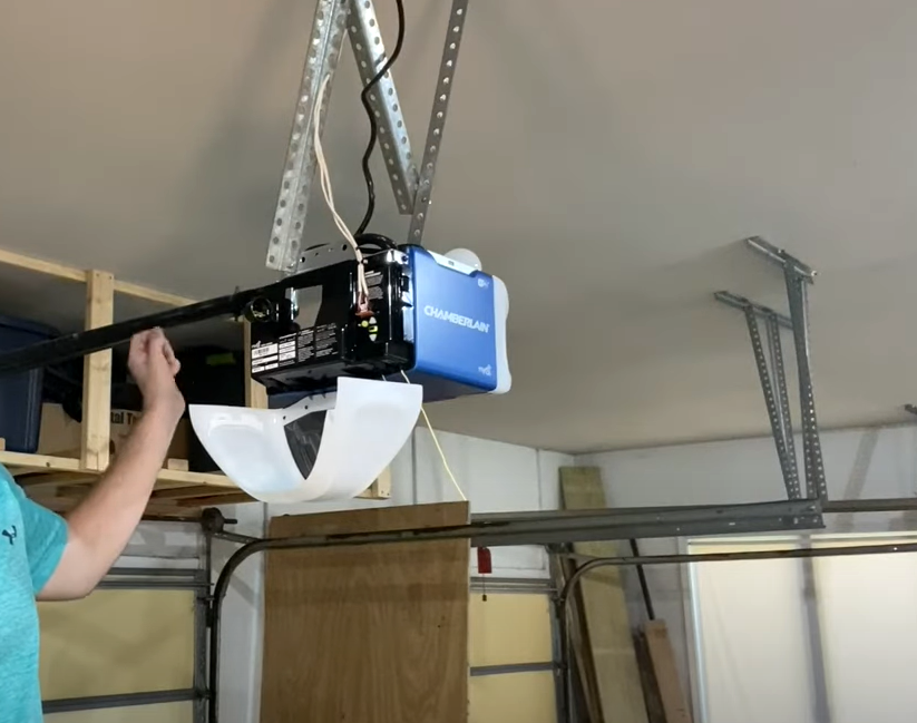 Professional technician installing a garage door opener in a residential home in Bradenton, FL, showcasing expert garage door opener installation services.