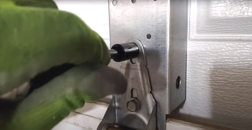 Professional technician fixing a noisy garage door in Bradenton, FL, using specialized tools for effective repair