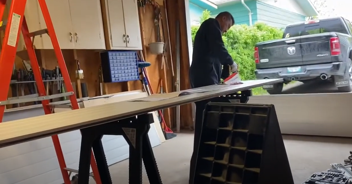 Professional technicians repairing a garage door in Bradenton, FL, showcasing expert garage door panel repair services with tools and equipment in the background