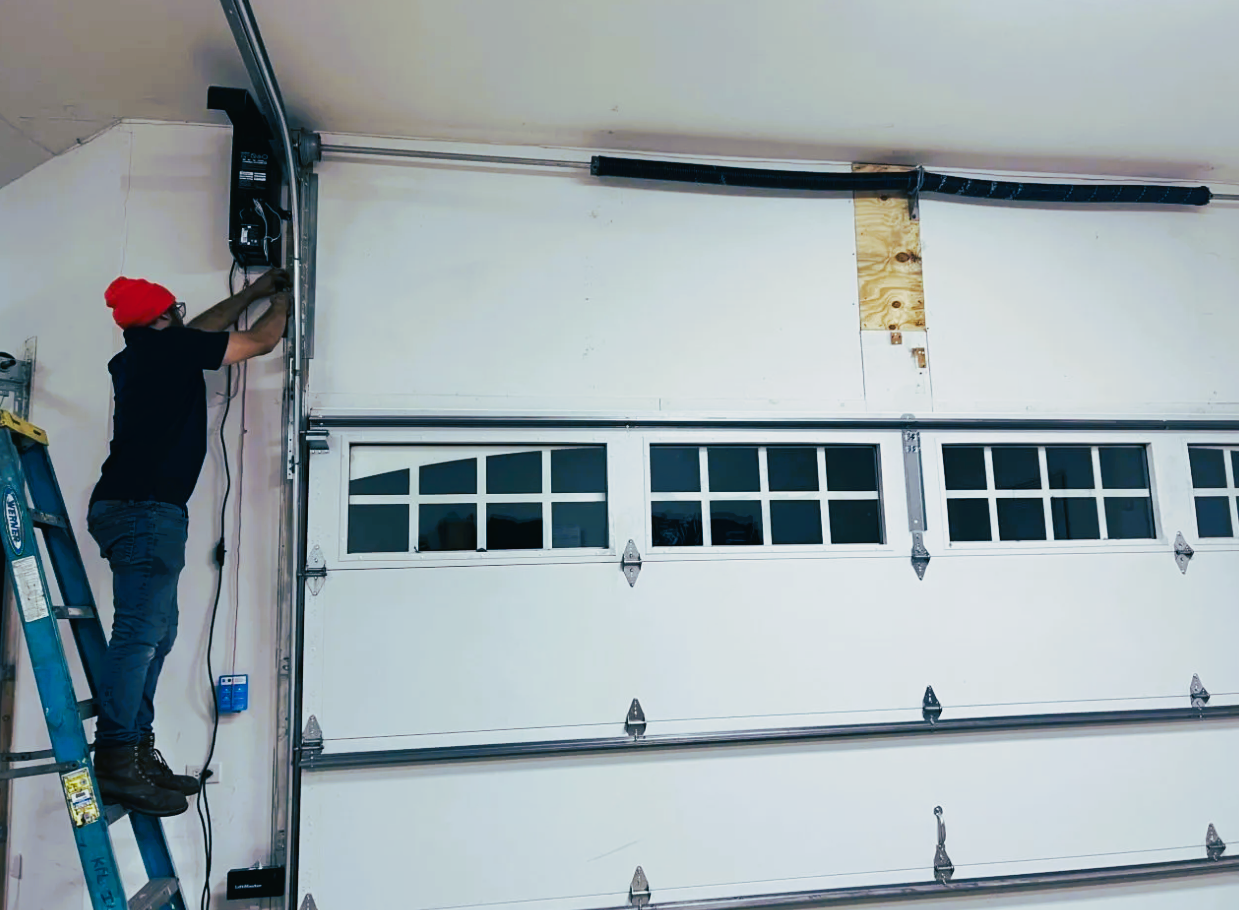 A professional technician expertly performing a garage door section replacement, highlighting the specialized repair services offered by Bradenton FL Garage Door Repair.