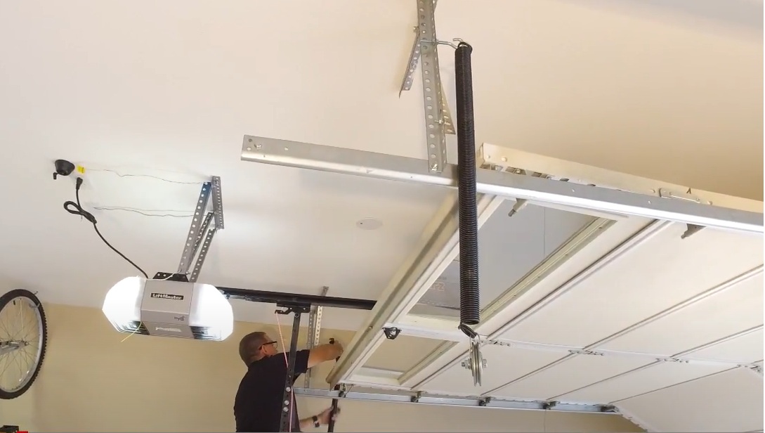 Professional technician performing overhead garage door repair in Bradenton, FL