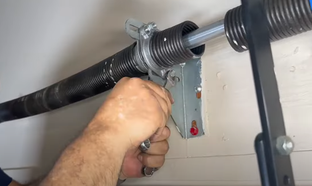 Technician performing garage door spring repair in Bradenton, FL.