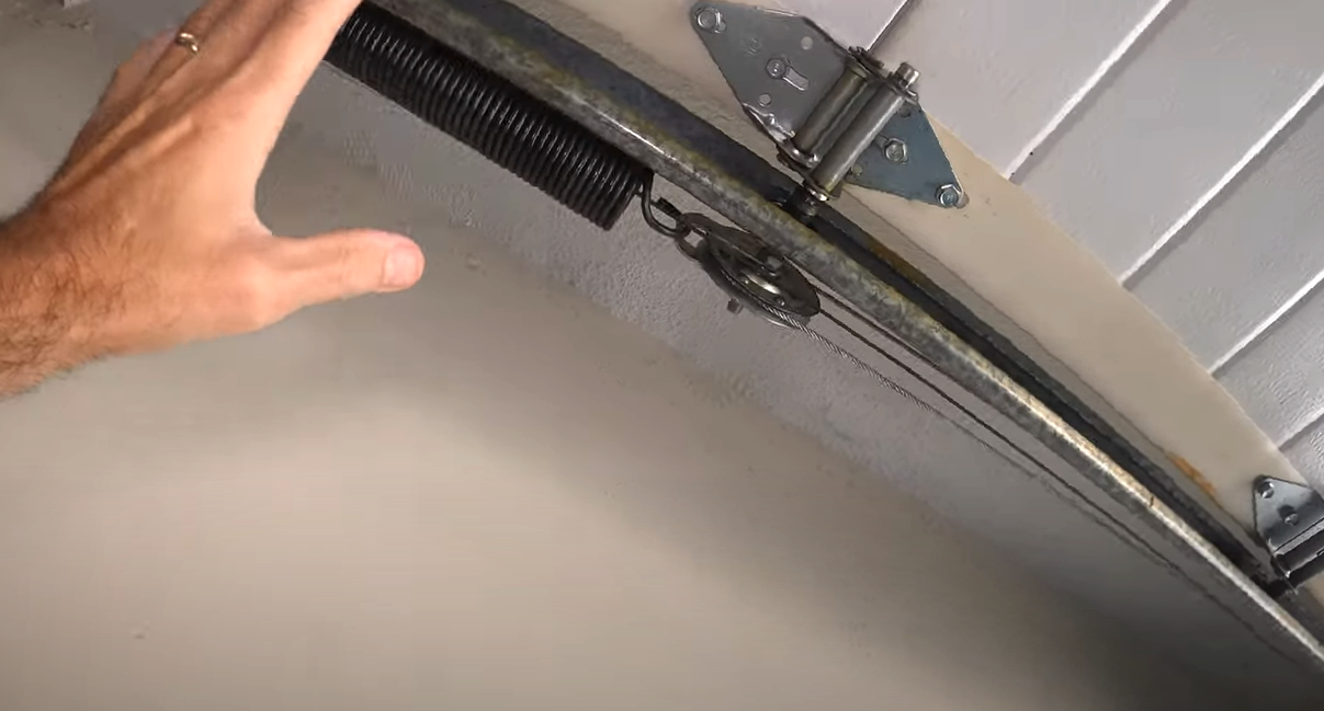 Technician performing garage door track repair in Bradenton, FL"