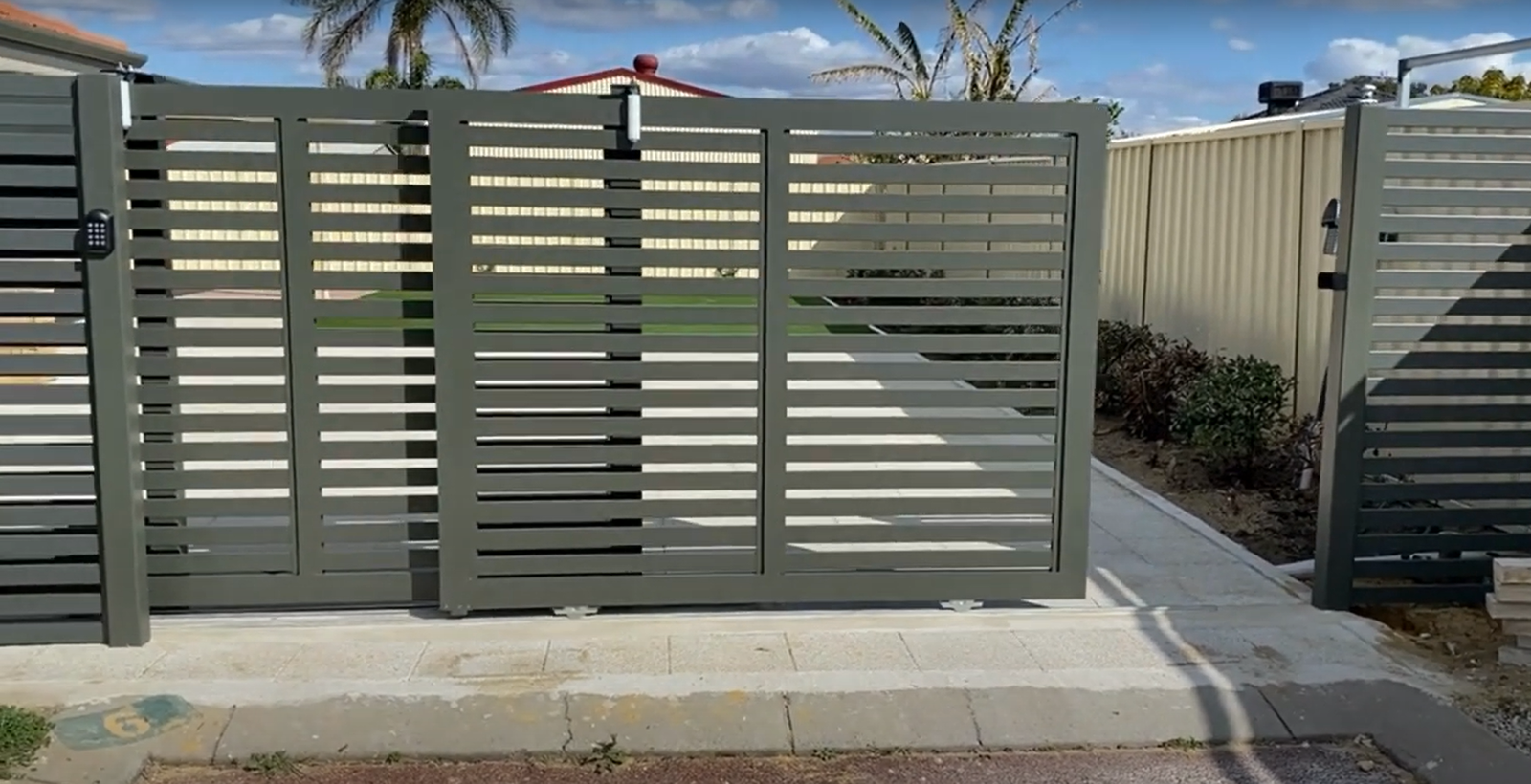 A professional technician performing residential gate repair in Bradenton, FL.