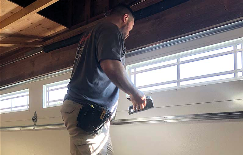 Close-up of a damaged garage door panel being repaired in Bradenton, FL, demonstrating professional garage door panel repair services